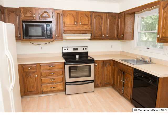 254 Lanes Pond Road Howell, NJ 07731 - Photo 5 of 16 a kitchen with stainless steel appliances granite countertop a stove microwave and cabinets