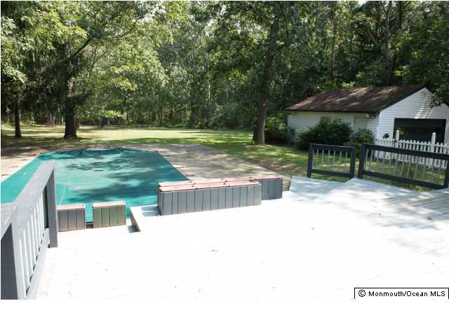 254 Lanes Pond Road Howell, NJ 07731 - Photo 10 of 16 a swimming pool with outdoor seating and yard