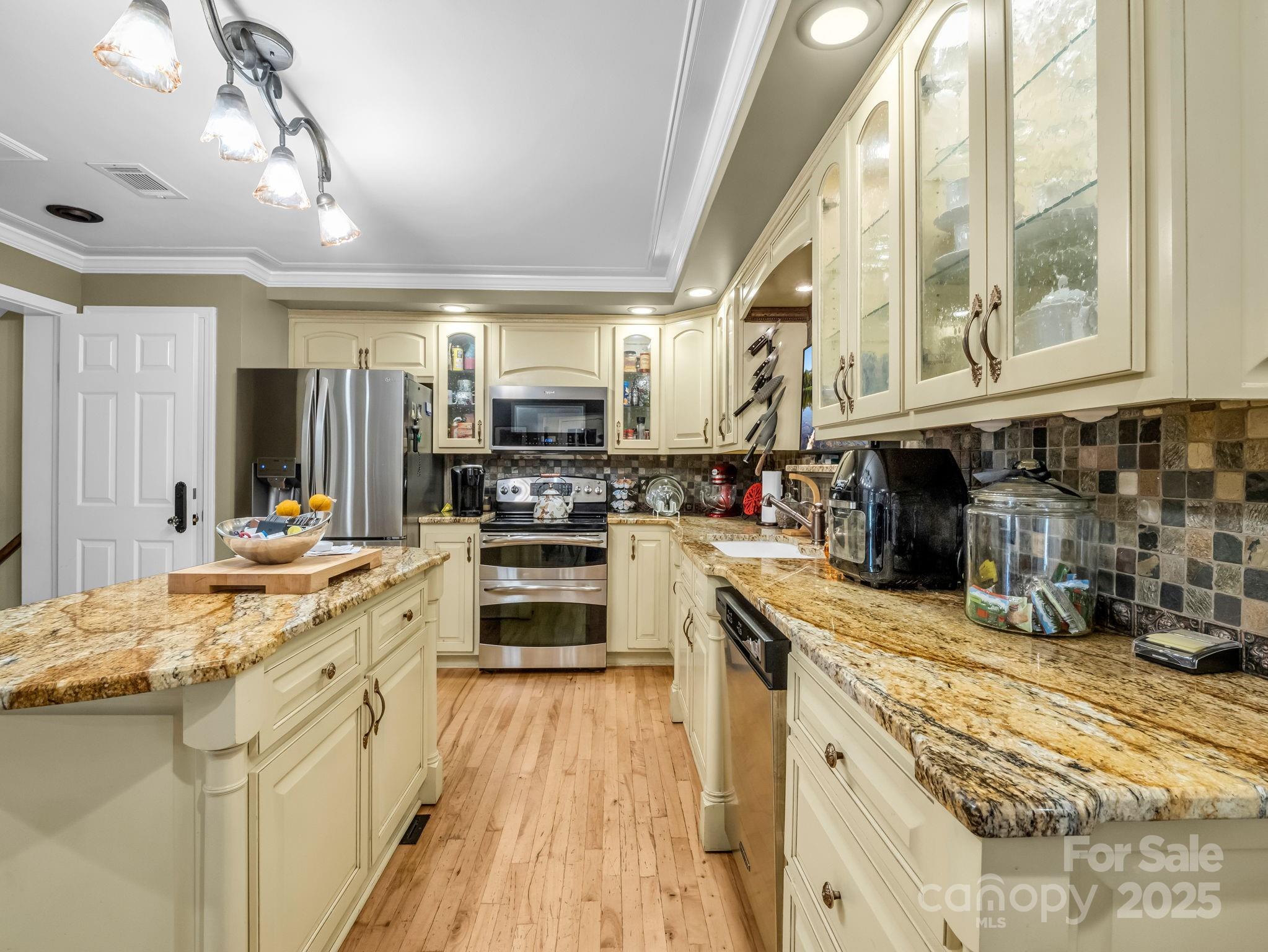 1102 South Mountain Road Bostic, NC 28018 - Photo 12 of 48 a kitchen with stainless steel appliances granite countertop a stove a sink and a microwave
