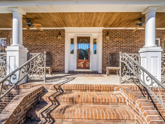 a view of a brick house with swimming pool