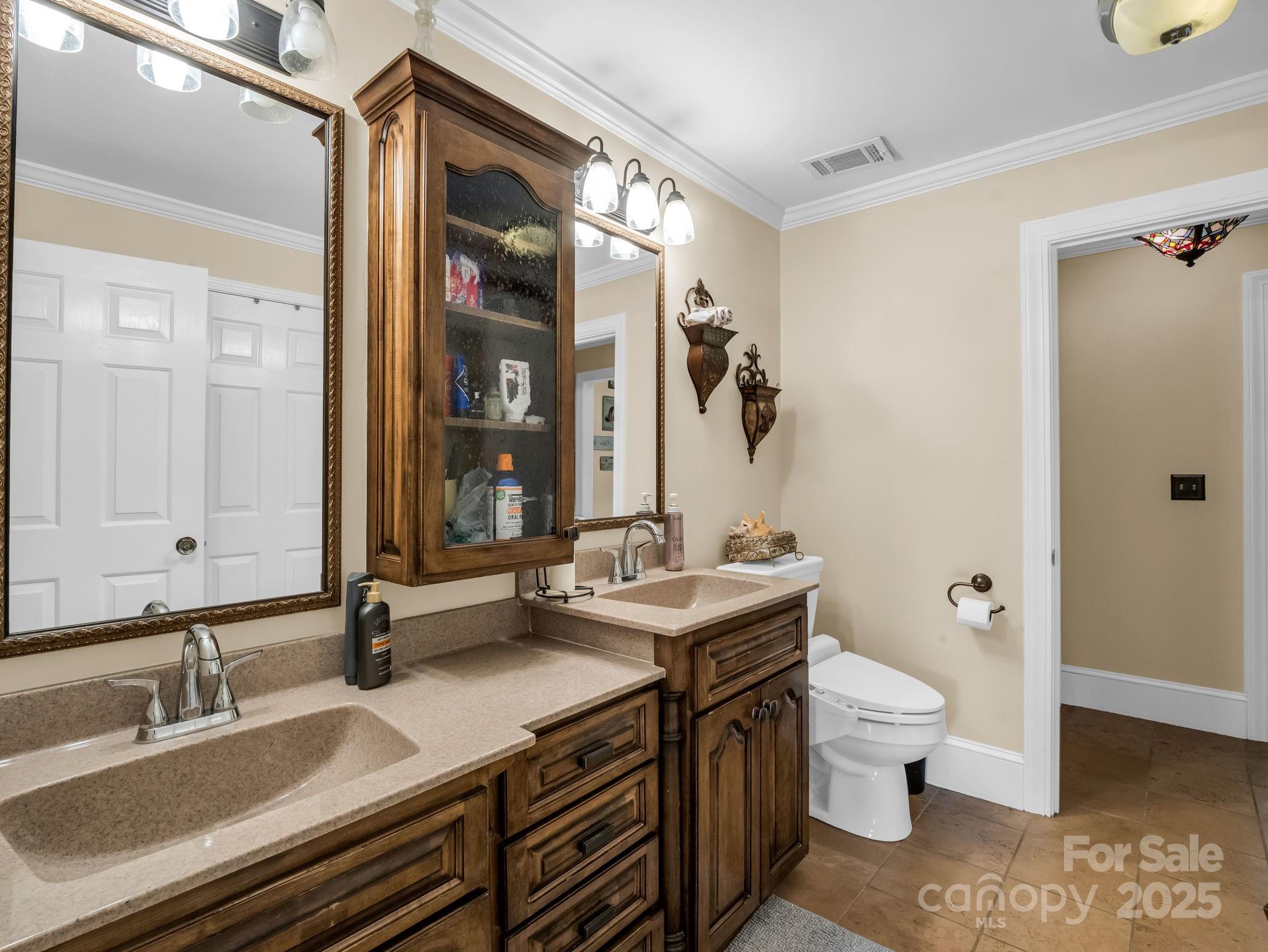 1102 South Mountain Road Bostic, NC 28018 - Photo 21 of 48 a bathroom with a granite countertop sink a toilet and a mirror