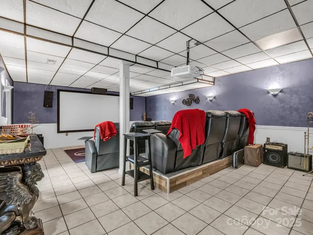 a dining room with furniture a chandelier and wooden floor