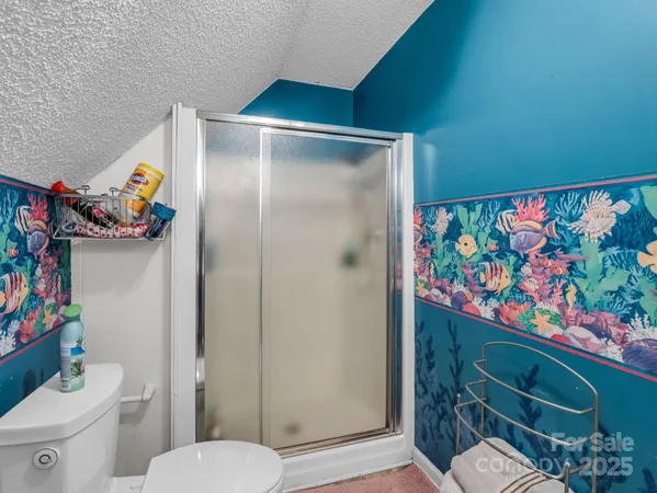 a bedroom with bed and a chandelier