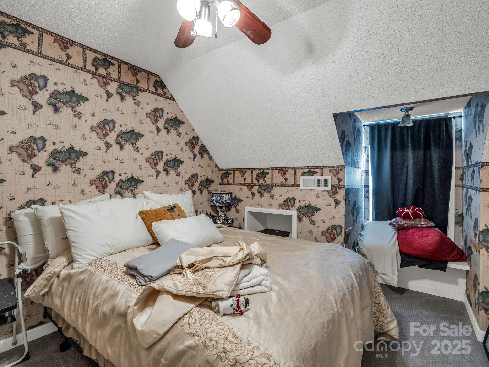 1102 South Mountain Road Bostic, NC 28018 - Photo 34 of 48 a bedroom with bed and a chandelier