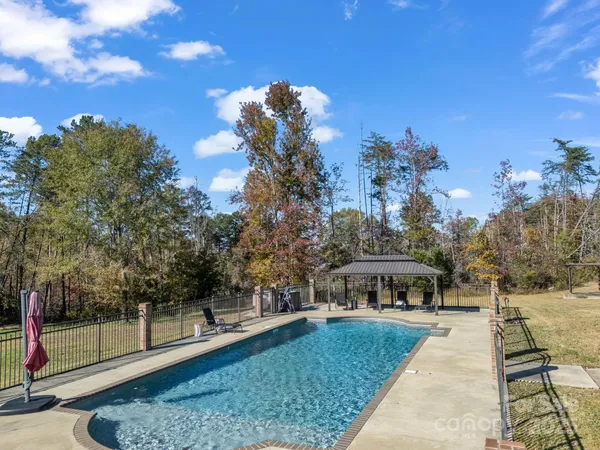 a view of a swimming pool with a yard