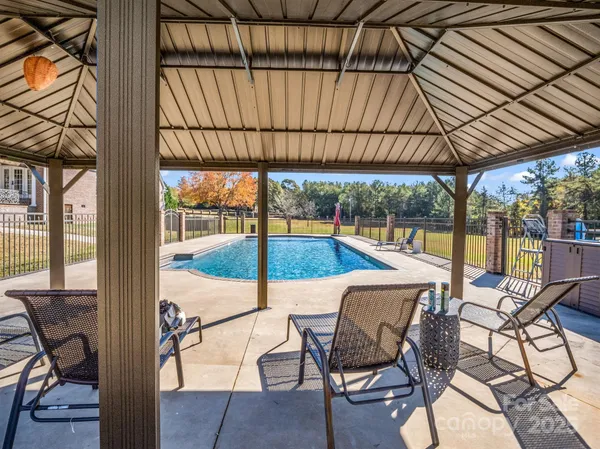 a front view of a house with swimming pool yard and outdoor seating