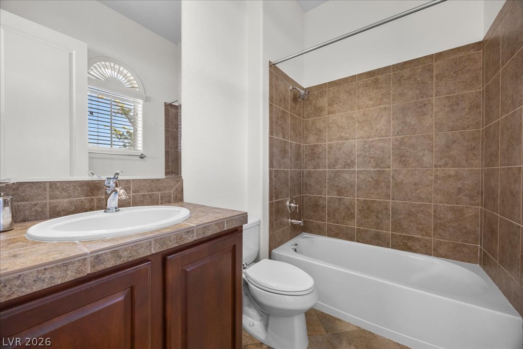 2125 De Rouge Avenue Henderson, NV 89044 - Photo 60 of 96 A well-maintained bathroom with a tiled shower and a modern vanity, ready for daily routines.