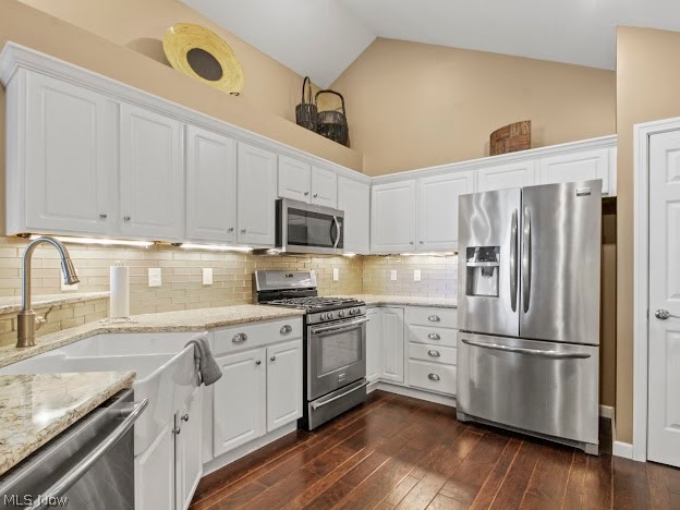 9151 Springfield Road, Unit 1201 Youngstown, OH 44514 - Photo 4 of 22 Kitchen featuring dark hardwood / wood-style flooring, backsplash, white cabinetry, and stainless steel appliances