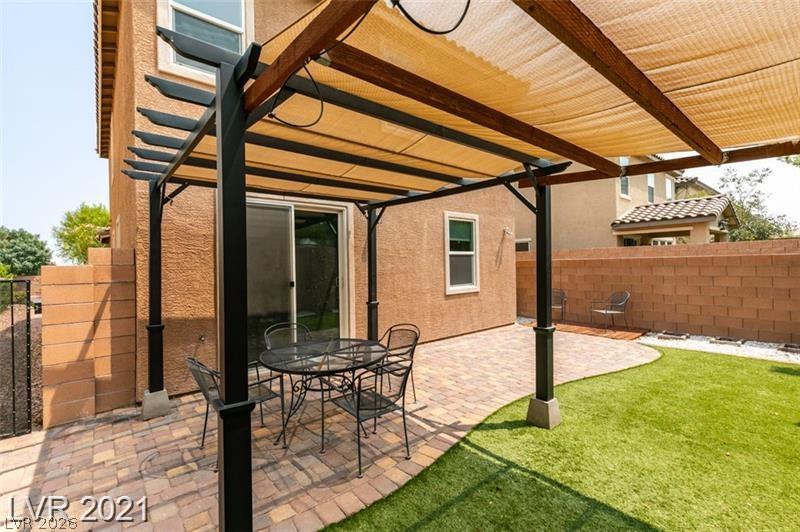 5475 Ordesa Valley Road Las Vegas, NV 89148 - Photo 9 of 35 Enjoy outdoor living on this charming patio featuring a pergola and synthetic grass landscaping.