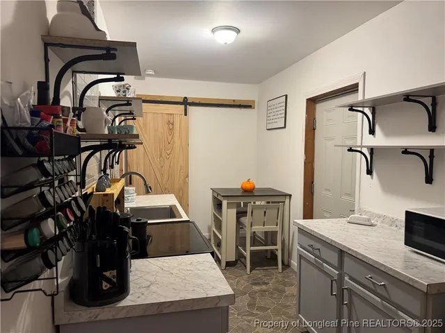 a view of a kitchen with a sink and cabinets