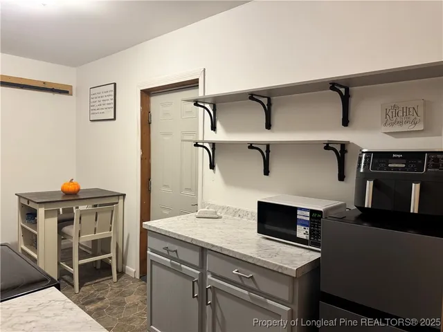 a view of kitchen with stainless steel appliances cabinets and stove
