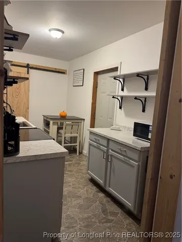 a kitchen that has a sink and a stove in it