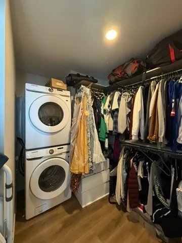 a view of walk in closet with clothes and shoes