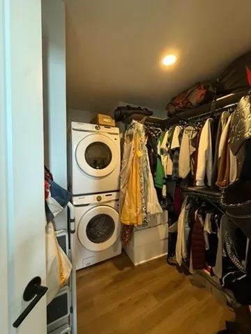 a view of walk in closet with clothes and shoes