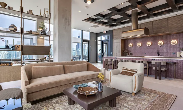 a living room with furniture and view of kitchen
