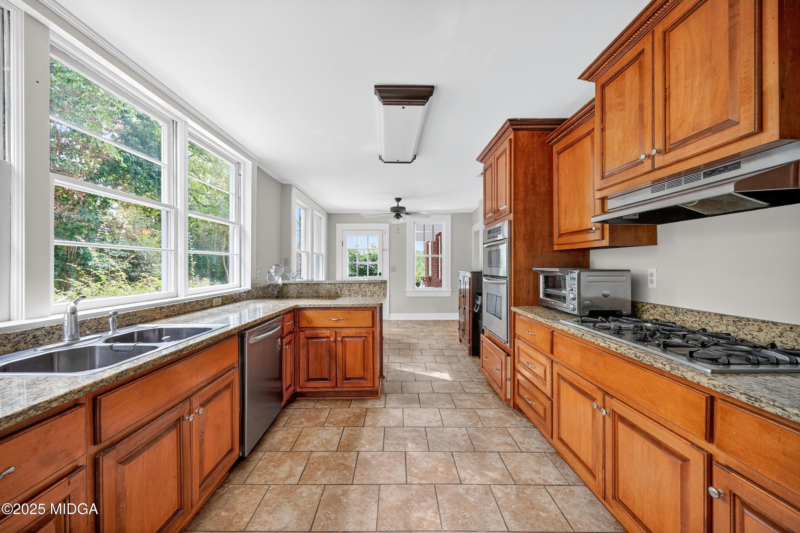 3341 Ridge Avenue Macon, GA 31204 - Photo 21 of 46 a large kitchen with stainless steel appliances granite countertop a stove a sink and a microwave