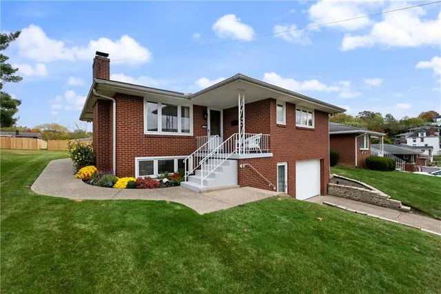 a front view of a house with a yard table and chairs