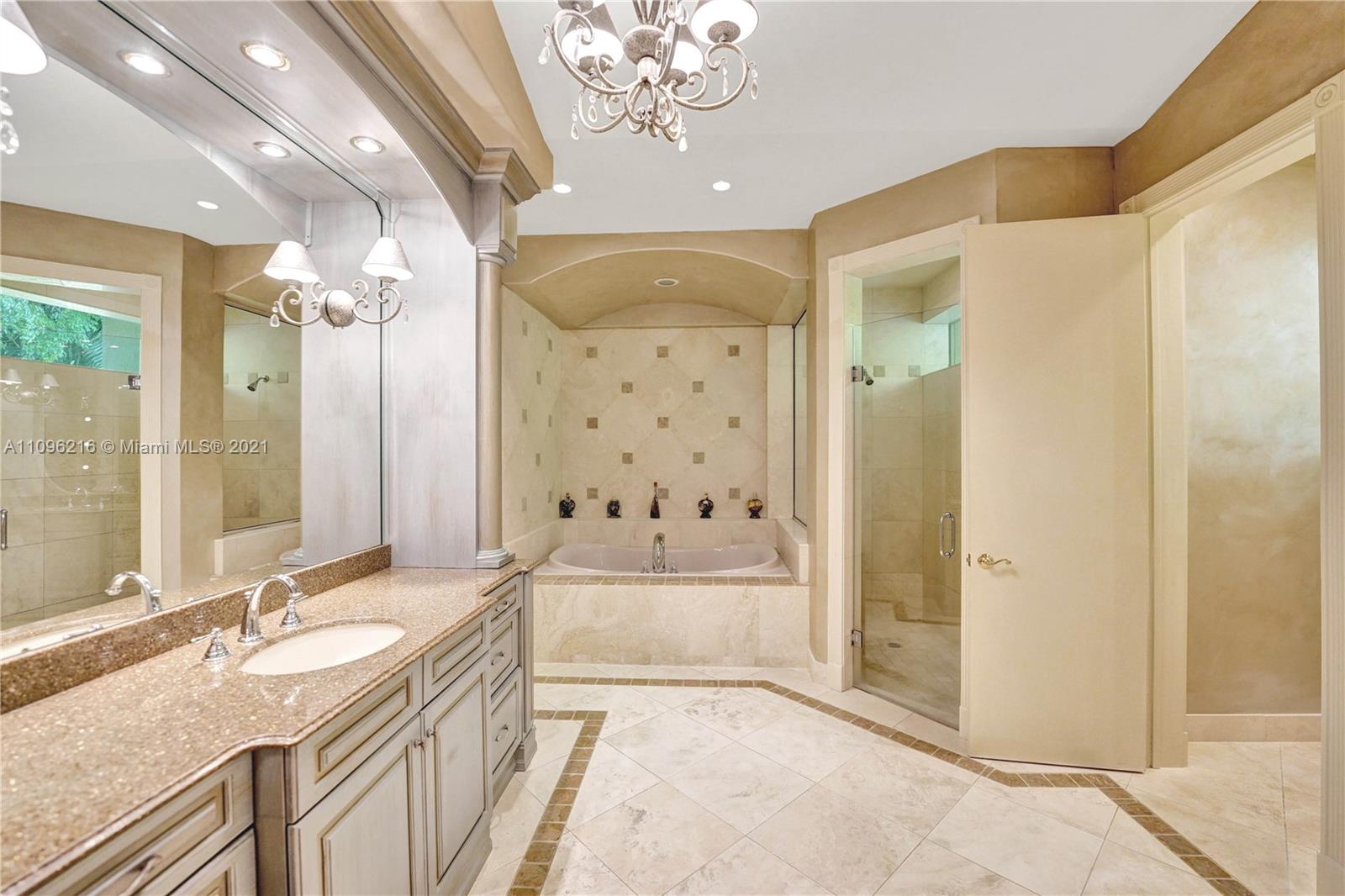 2755 Paddock Road Weston, FL 33331 - Photo 17 of 51 a spacious bathroom with a granite countertop sink a large mirror a shower and a bathtub