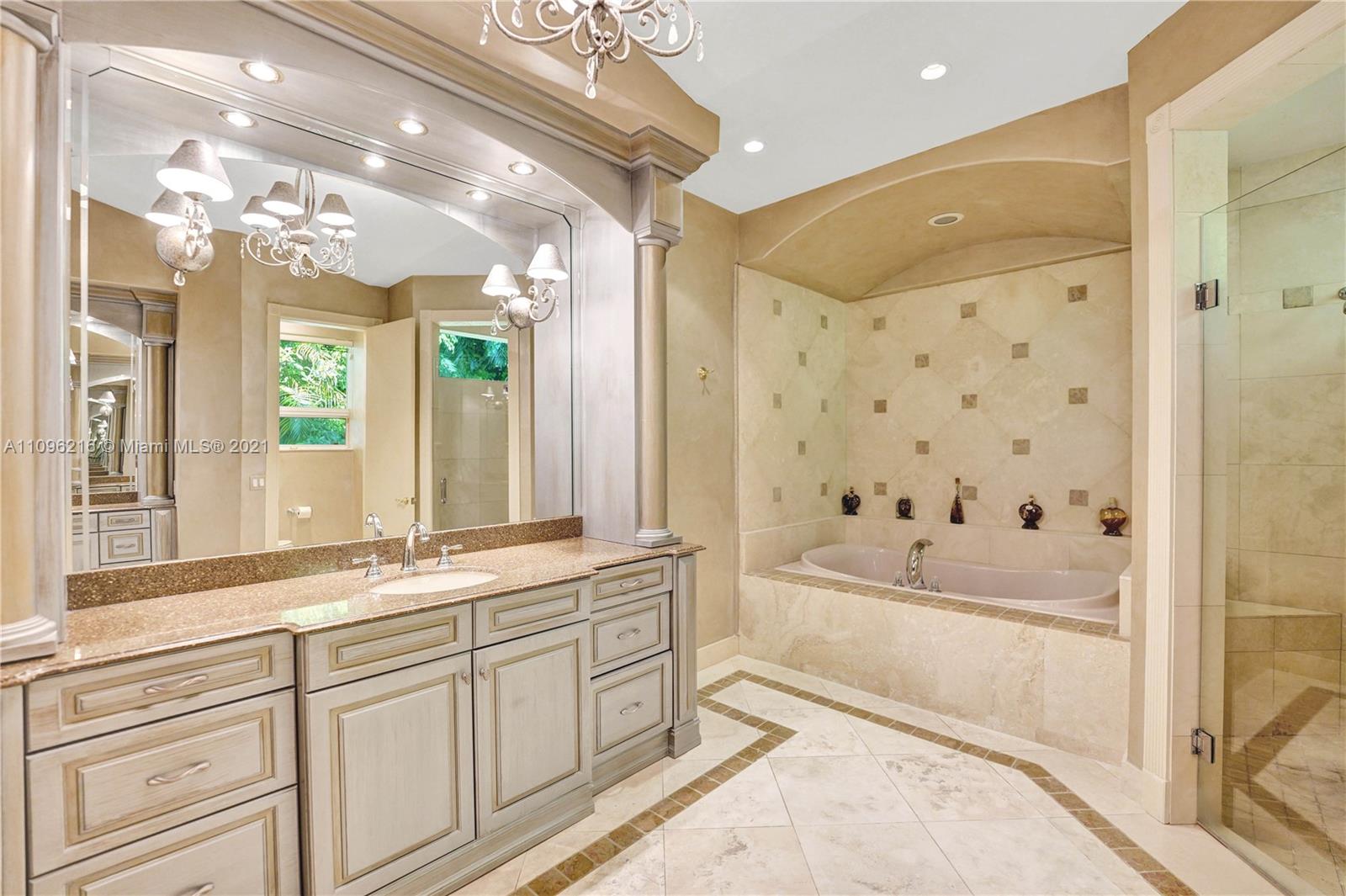 2755 Paddock Road Weston, FL 33331 - Photo 18 of 51 a bathroom with a bathtub a sink and a large mirror
