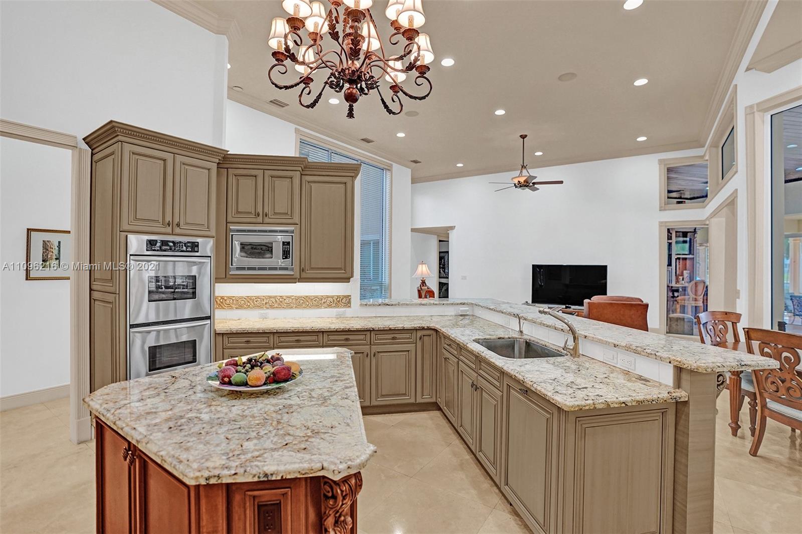 2755 Paddock Road Weston, FL 33331 - Photo 20 of 51 a kitchen with a stove a counter space and a sink