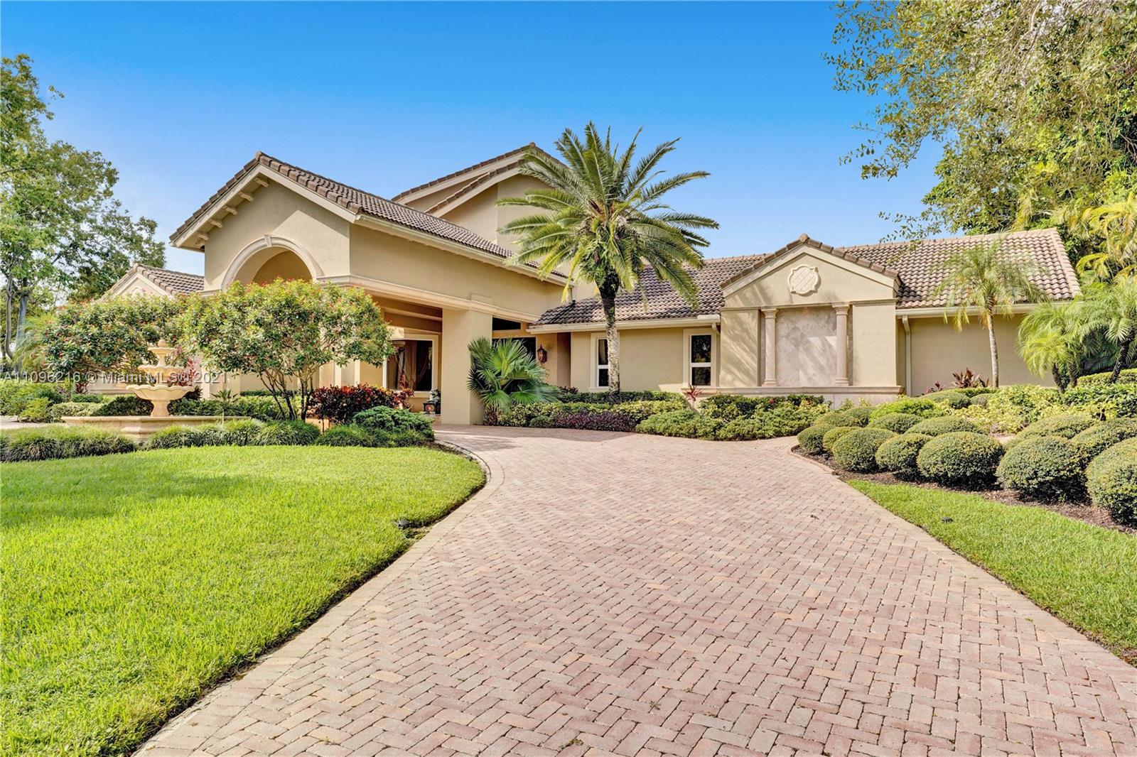 2755 Paddock Road Weston, FL 33331 - Photo 2 of 51 a front view of a house with a garden and plants