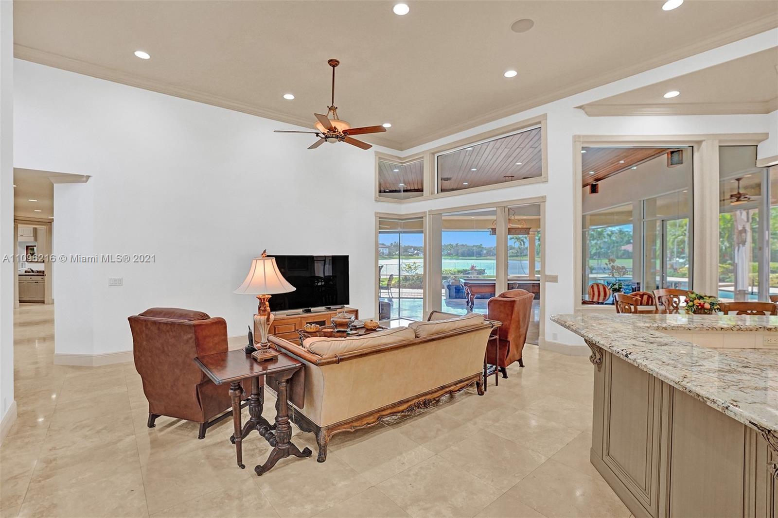 2755 Paddock Road Weston, FL 33331 - Photo 22 of 51 a living room with furniture a flat screen tv and a large window