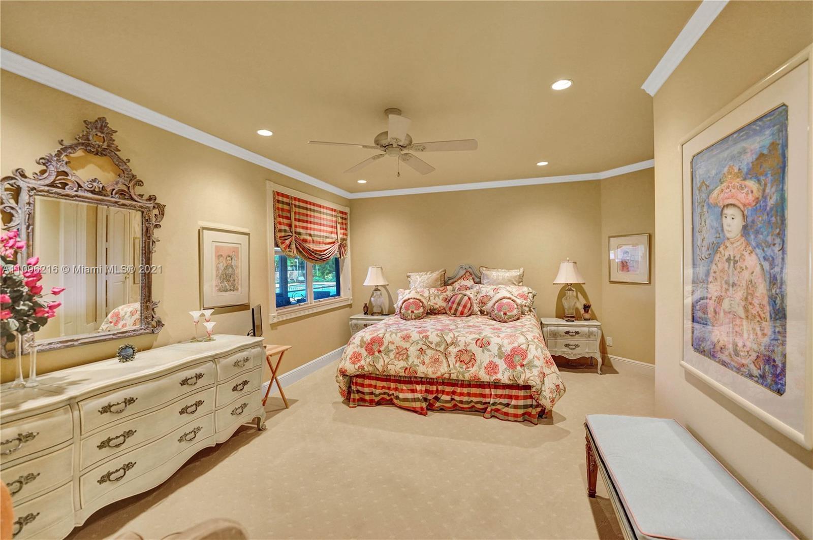 2755 Paddock Road Weston, FL 33331 - Photo 29 of 51 a bedroom with double bed and a chandelier