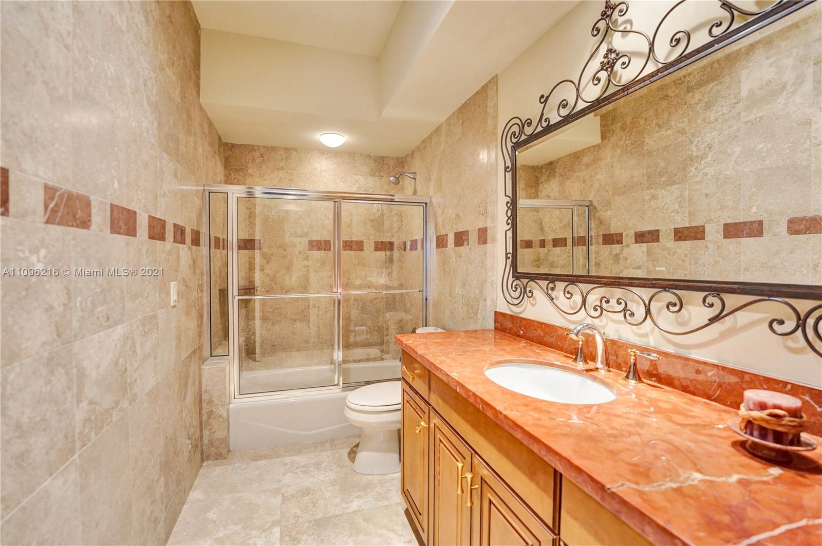 2755 Paddock Road Weston, FL 33331 - Photo 38 of 51 a bathroom with a sink a toilet a mirror and shower