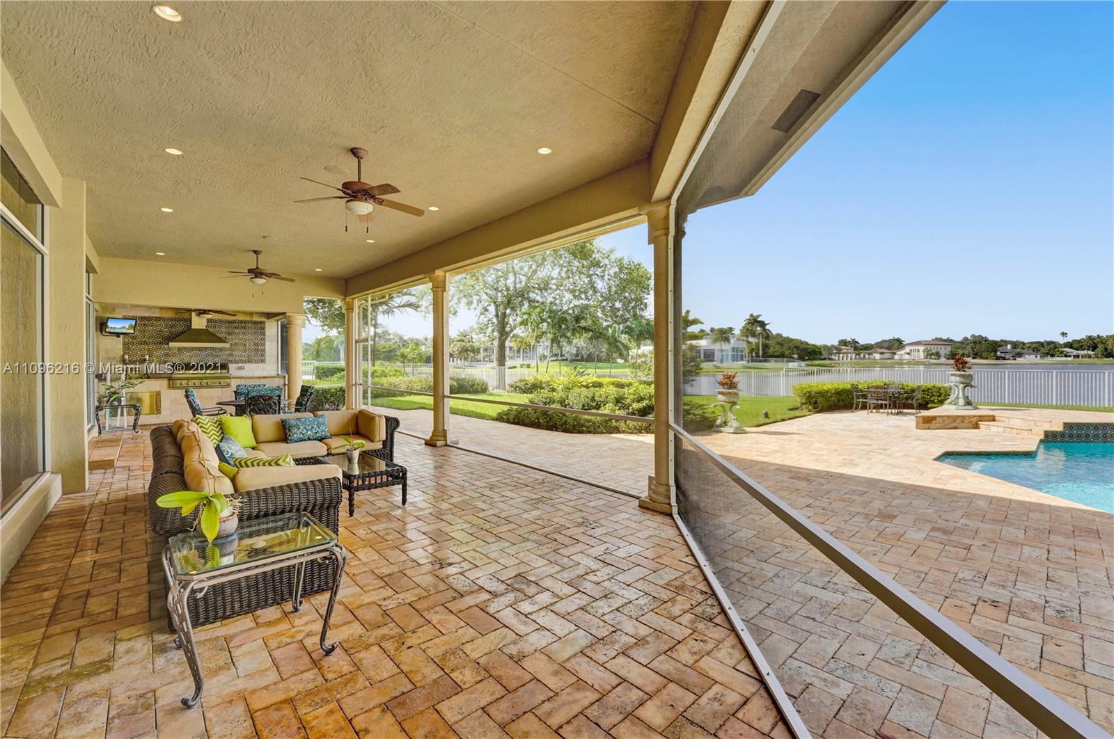 2755 Paddock Road Weston, FL 33331 - Photo 41 of 51 a living room with patio furniture and a ocean view