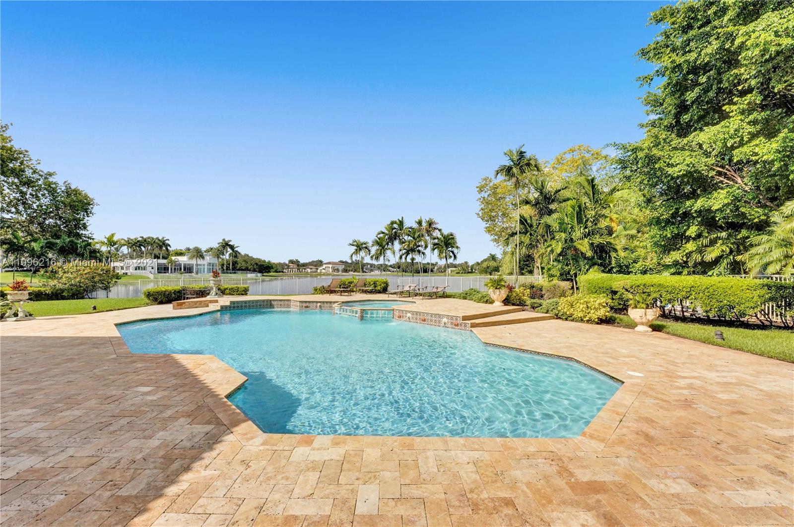 2755 Paddock Road Weston, FL 33331 - Photo 44 of 51 a view of a swimming pool and lake
