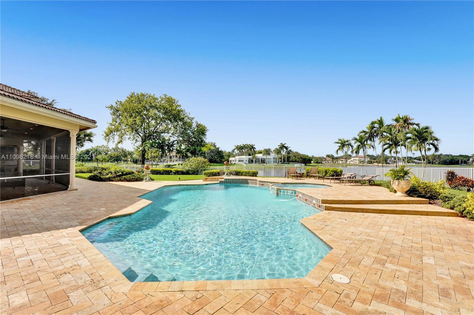 2755 Paddock Road Weston, FL 33331 - Photo 45 of 51 a view of swimming pool with outdoor seating and plants