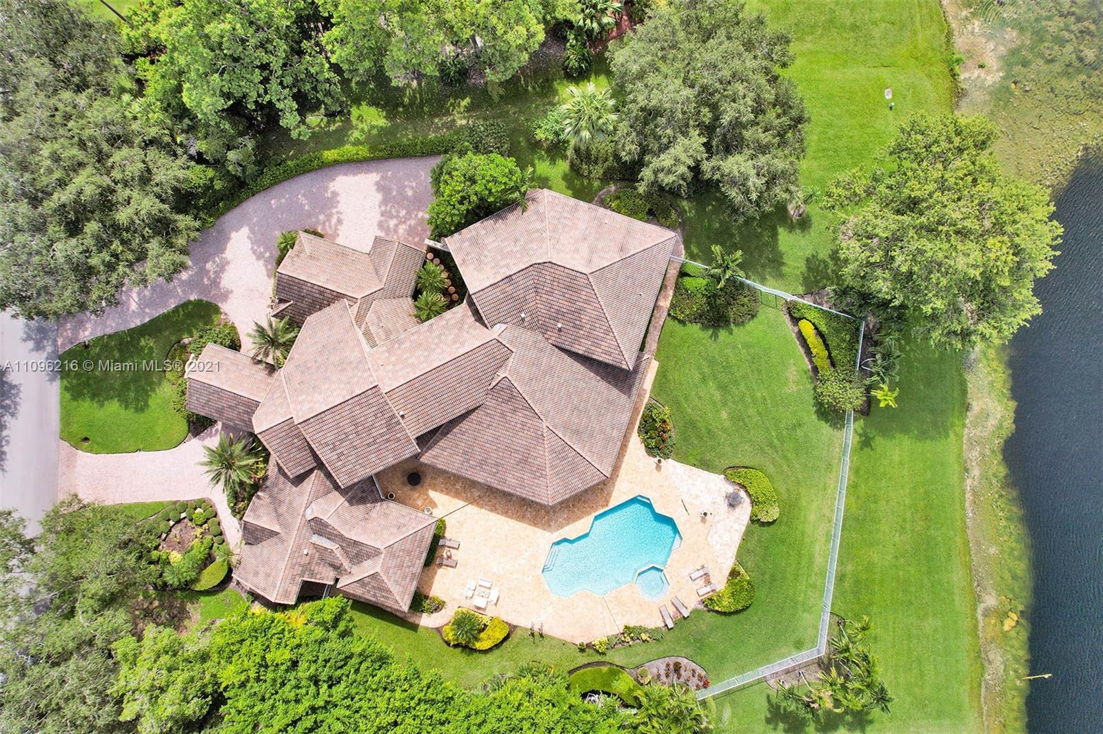 2755 Paddock Road Weston, FL 33331 - Photo 50 of 51 an aerial view of a house with garden space and street view