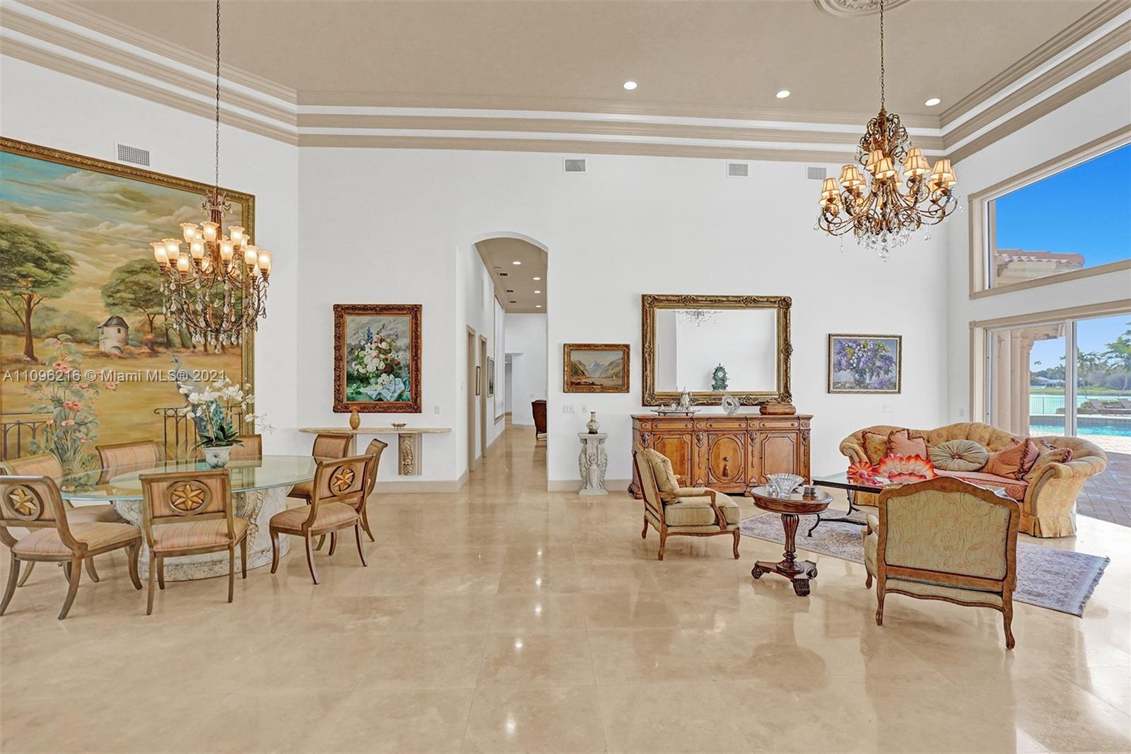 2755 Paddock Road Weston, FL 33331 - Photo 6 of 51 a living room with furniture a chandelier and a large window