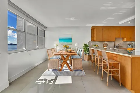 a dinning area with glass windows and table