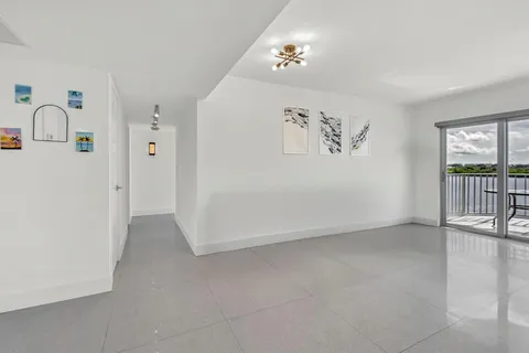 a view of a big room with potted plants and couches chairs