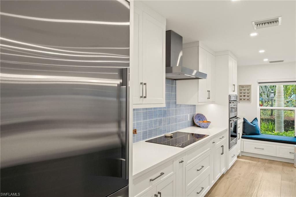 1060 6th Street South, Unit 1060 Naples, FL 34102 - Photo 12 of 26 a bathroom with a sink a bathtub and window