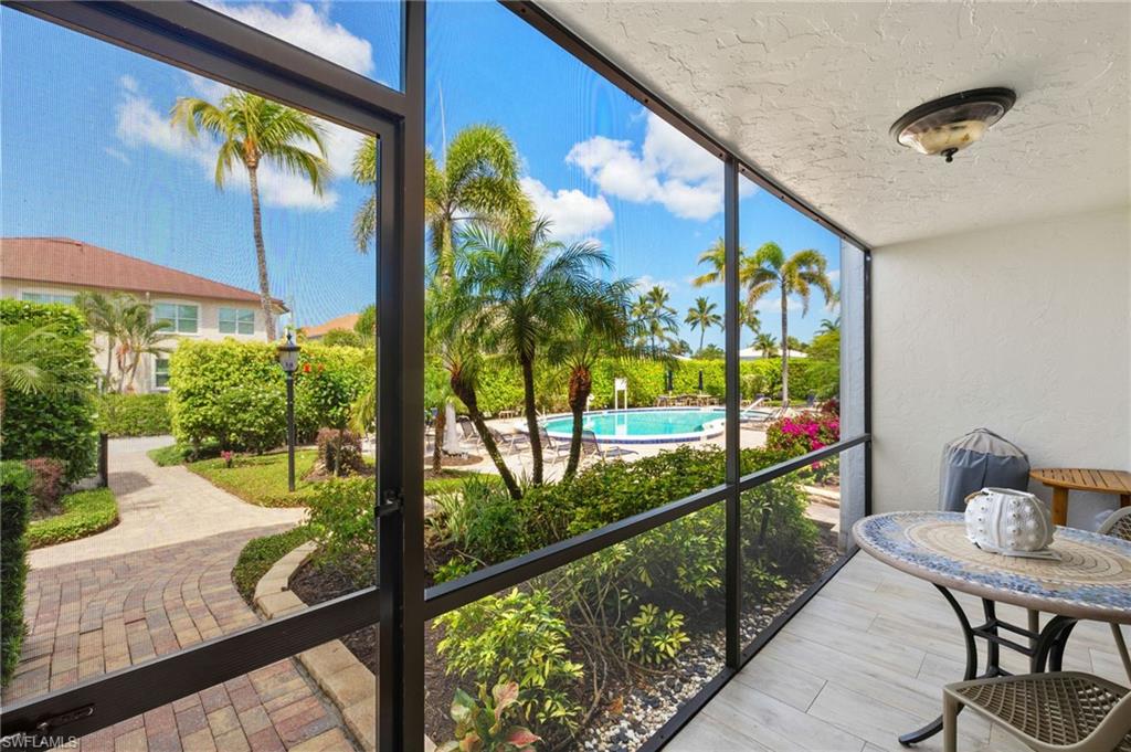 1060 6th Street South, Unit 1060 Naples, FL 34102 - Photo 25 of 26 a view of a chairs and table in a balcony