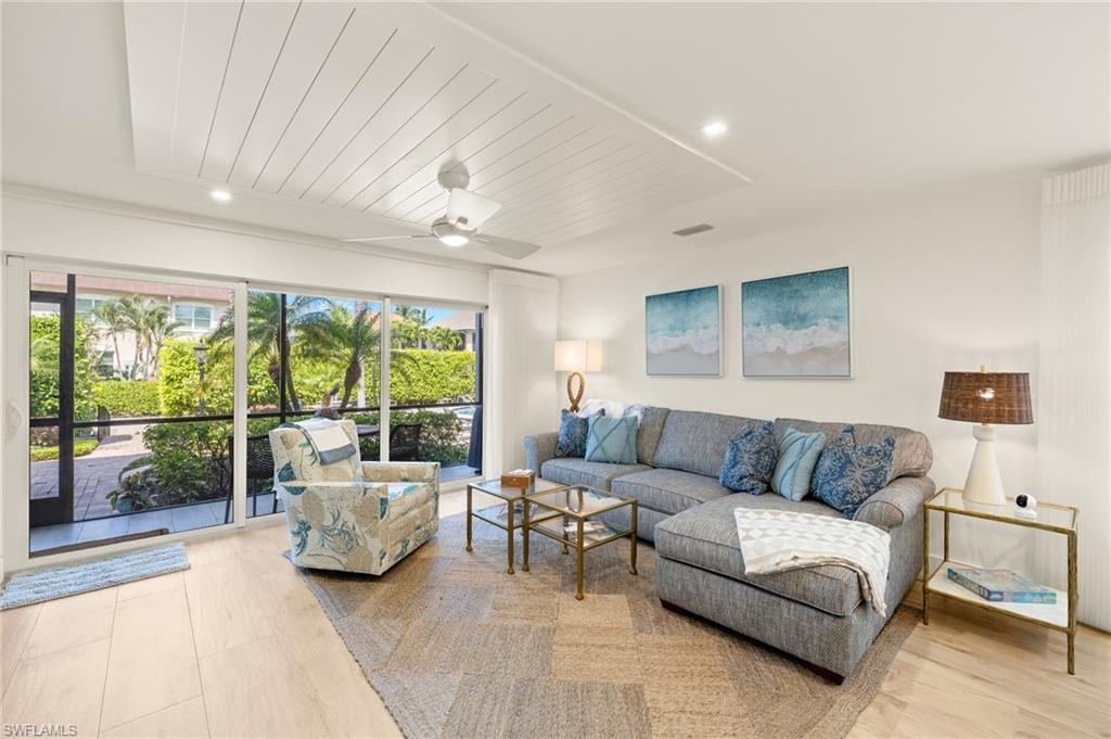 1060 6th Street South, Unit 1060 Naples, FL 34102 - Photo 3 of 26 a living room with furniture and a large window