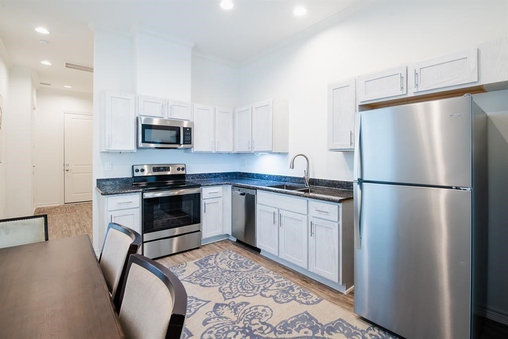 2524 Sam Wilson Street Houston, TX 77020 - Photo 3 of 6 a kitchen with stainless steel appliances a refrigerator sink and microwave