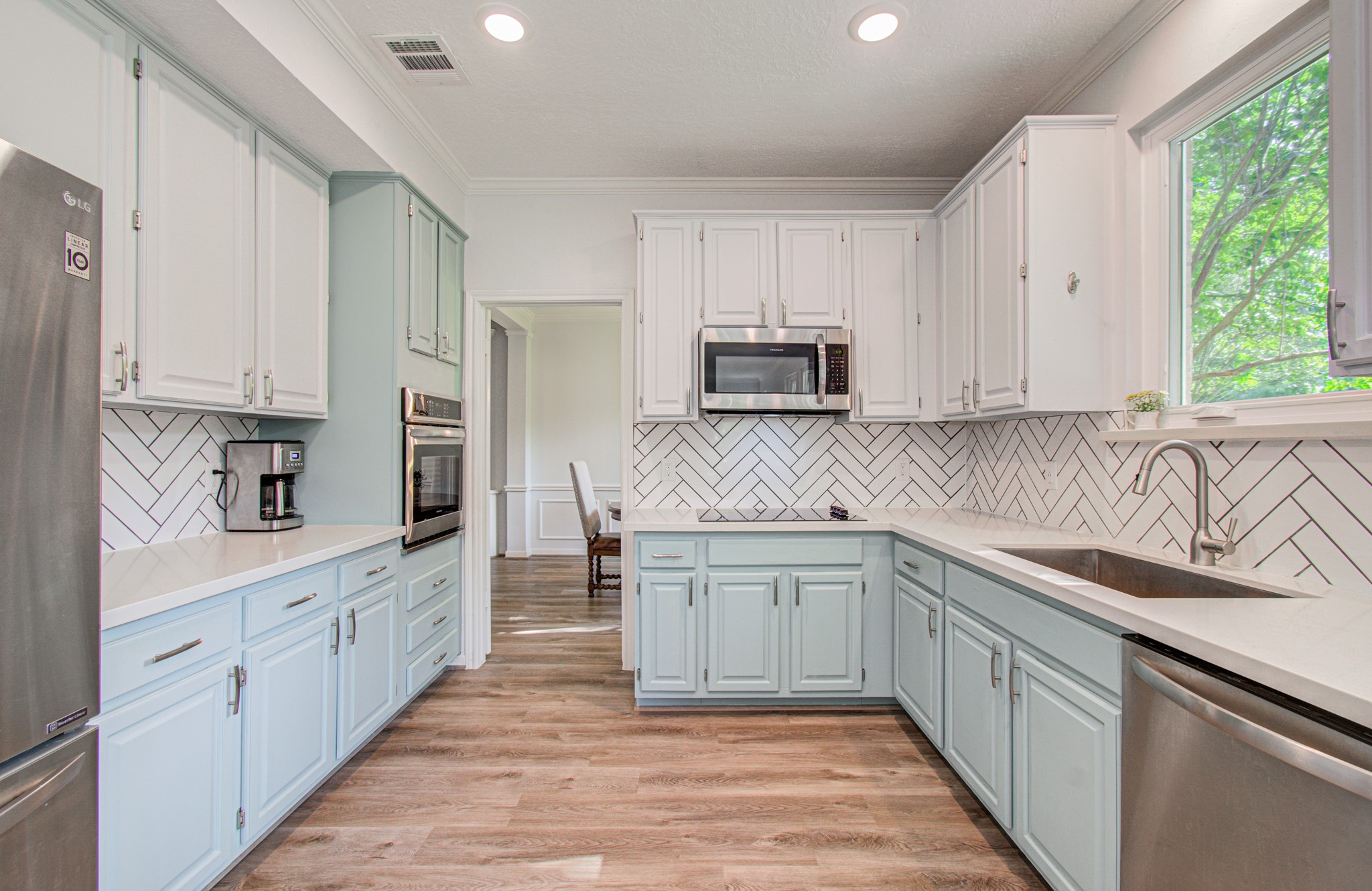 22927 Northoak Forest Lane Spring, TX 77389 - Photo 9 of 37 a kitchen with stainless steel appliances granite countertop a sink and cabinets
