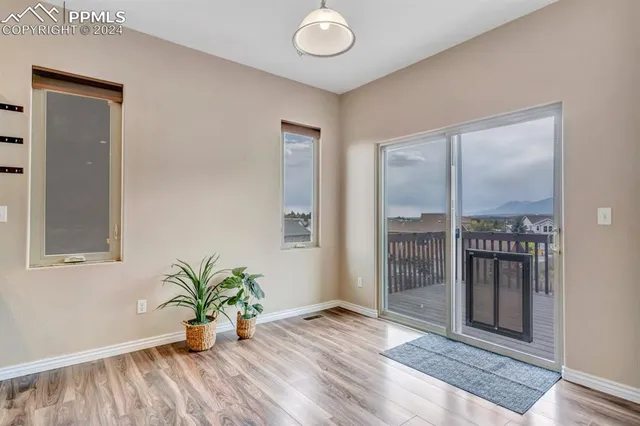 a view of livingroom with entryway and wooden floor