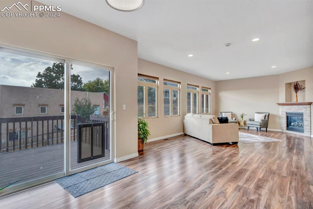 861 Circle Road Palmer Lake, CO 80133 - Photo 12 of 41 a living room with furniture and a floor to ceiling window