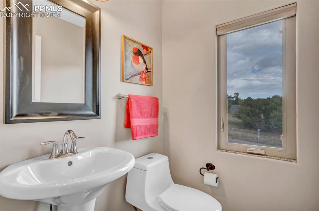 861 Circle Road Palmer Lake, CO 80133 - Photo 13 of 41 a bathroom with a toilet sink and mirror