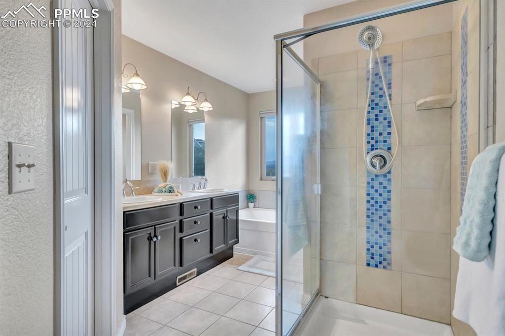 861 Circle Road Palmer Lake, CO 80133 - Photo 20 of 41 a spacious bathroom with a shower and a sink