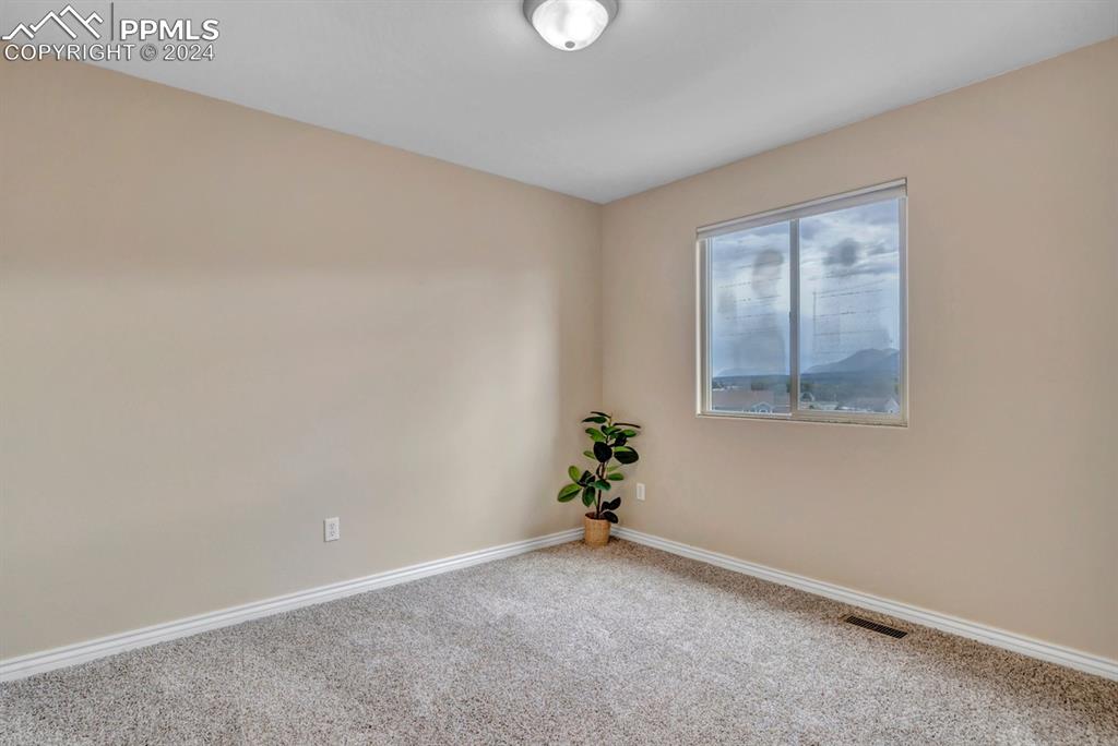 861 Circle Road Palmer Lake, CO 80133 - Photo 24 of 41 an empty room with windows