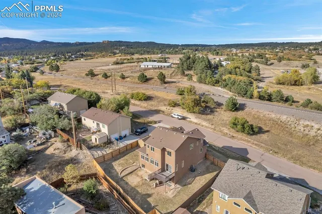 an aerial view of residential houses with outdoor space