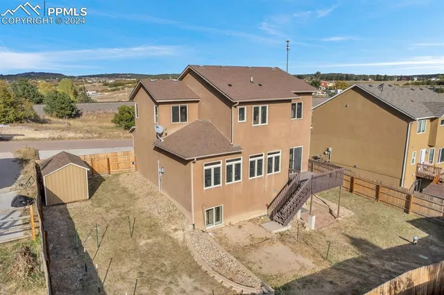 an aerial view of residential houses with outdoor space