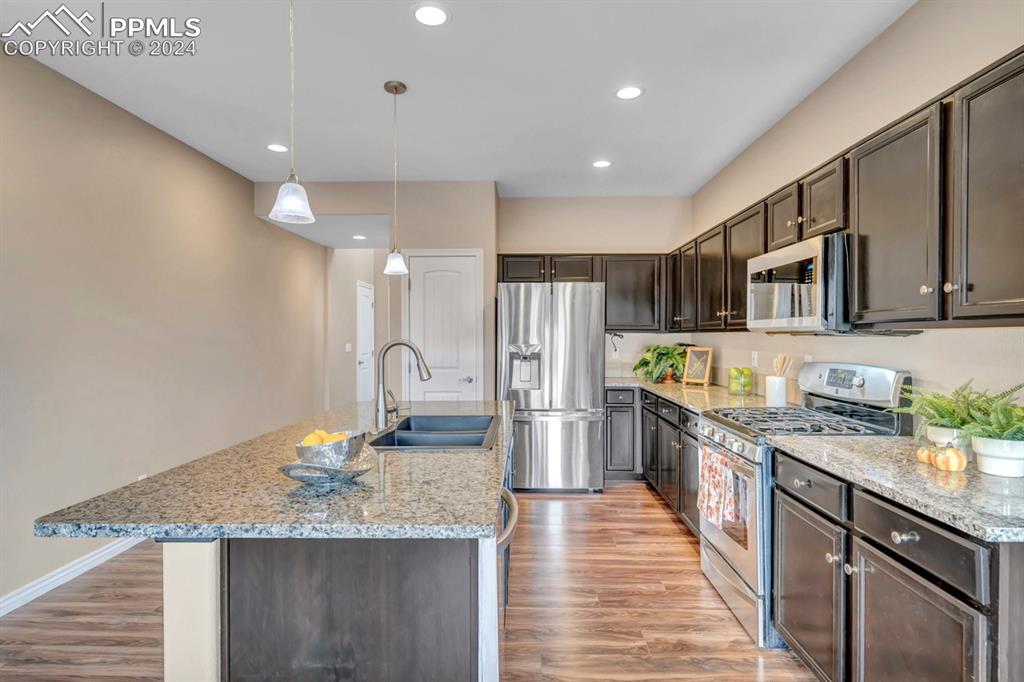 861 Circle Road Palmer Lake, CO 80133 - Photo 10 of 41 a kitchen with stainless steel appliances granite countertop a sink stove and refrigerator
