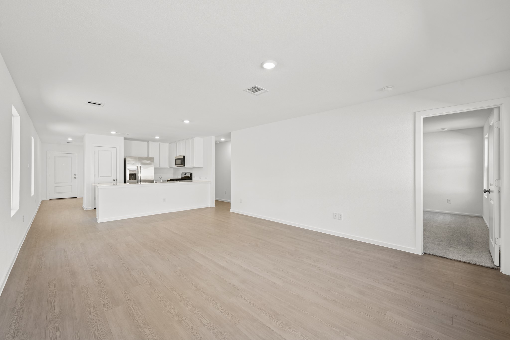 10583 Altitude Way Conroe, TX 77303 - Photo 19 of 33 a view of a big room with kitchen island and wooden floor
