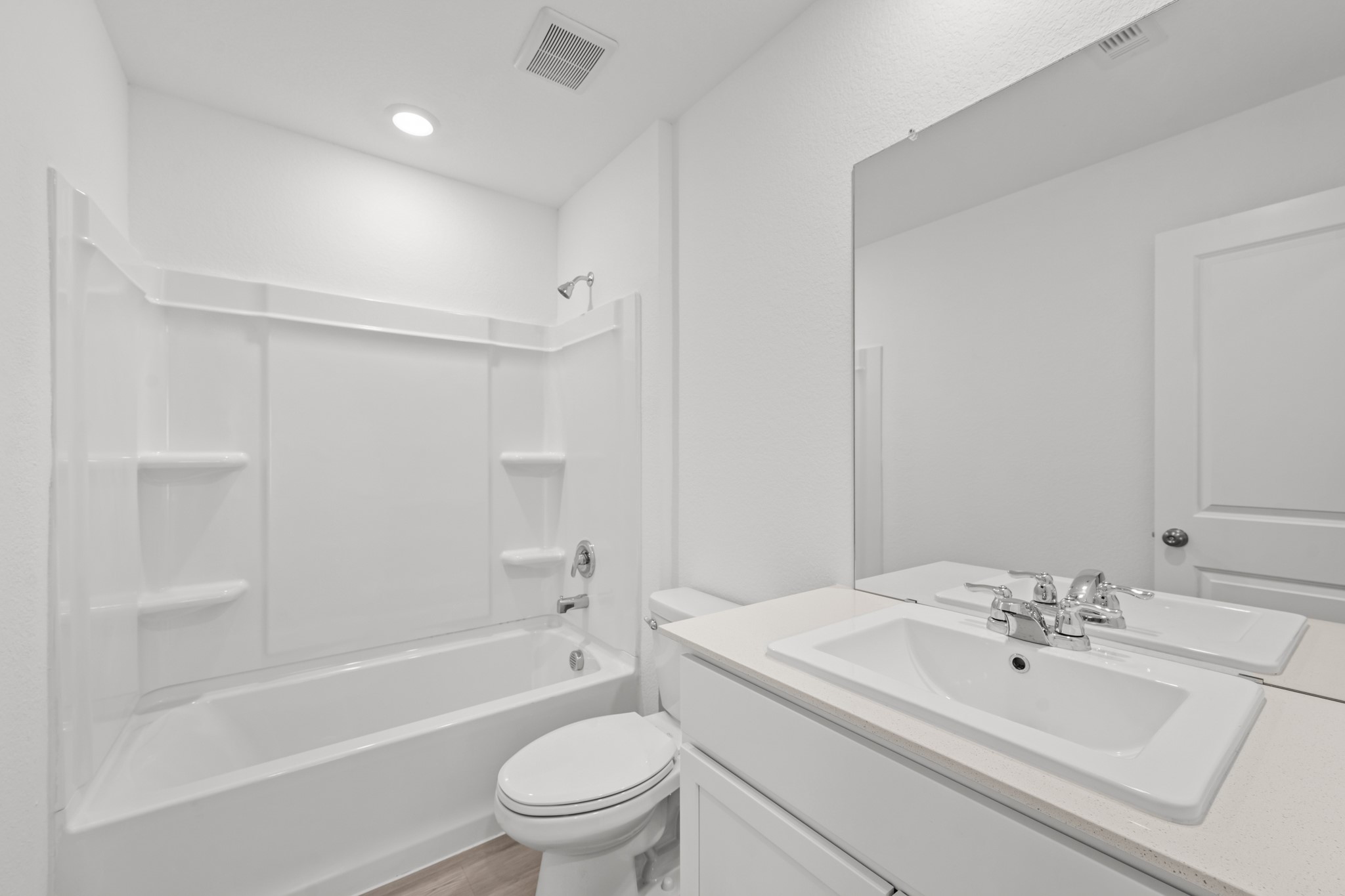 10583 Altitude Way Conroe, TX 77303 - Photo 20 of 33 a bathroom with a bathtub shower sink vanity mirror and toilet